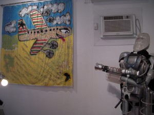 Eric Abaka's painting on a shower curtain faces off with a Dino Vazquez robot.
