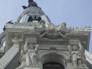 Looking up at the surreal gargoyles and statuary atop the Northeast corner of City Hall. Inside the art is locked in glass cases.