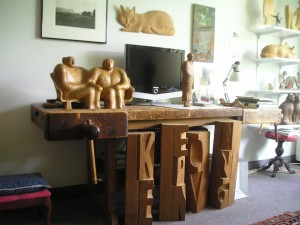 Keyser's woodworking bench with sculptures; the carved letters which spell "Keep Moving" were the last works she made