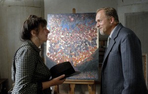 Seraphine shows Wilhelm her paintings and he buys some. Later he will be her patron and exhibit her works in Paris.