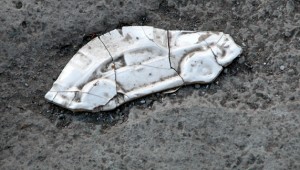 Eric Reyes Lamothe's ceramic squashed car on concrete.