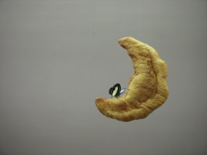 Urs Fischer, Coupadre, 2009, fishing line, croissant and butterfly
