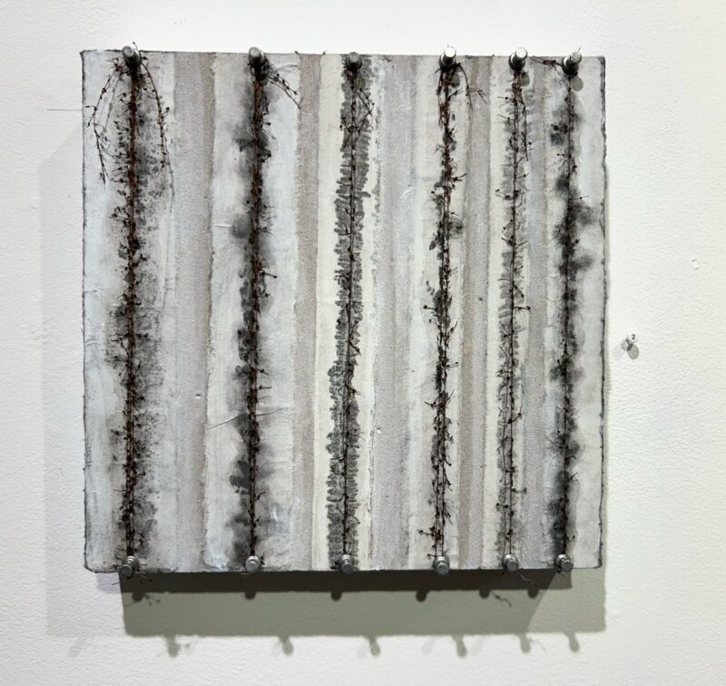 A small work on canvas with white, grey and black vertical stripes made with ink and string, with the strings push-pinned on top and bottom suggests the passage of time, or perhaps, if the stripes were horizontal, a medical read-out of a heart condition.