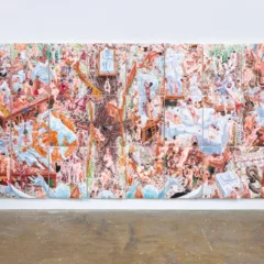 A young man in brown pants and blue short-sleeved shirt stands to the left looking up at a massive, 27-panel artwork of swirling figures, all nude, doing some kind of building work in a hellish, unstable, mid-air universe.