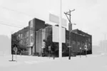 A black and white photo shows a large public school in Philadelphia which once had been segregated and for Blacks only.