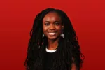 A young, long-haired Black woman wearing black and white earrings and a white necklace on a black sweater smiles broadly at you surrounded by a background of deep red.