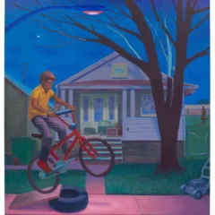 A painting shows a Black boy riding a bike over a hand-made ramp made of a plank of wood and a black rubber tire, with a one-story house and a leafless tree in the background, and a street light shining down making the sidewalk pink.